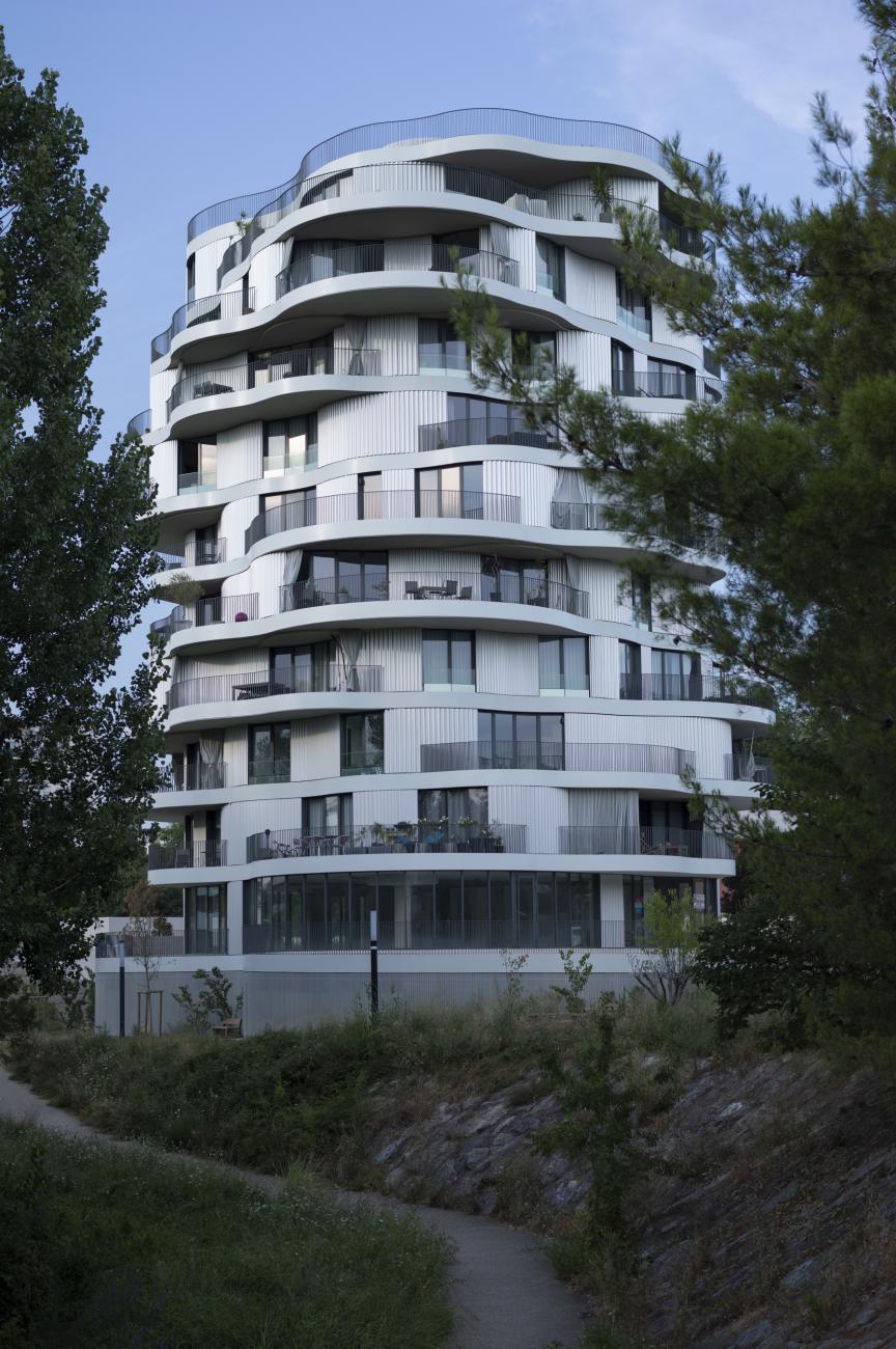 White building with several floors and overlapping balconies