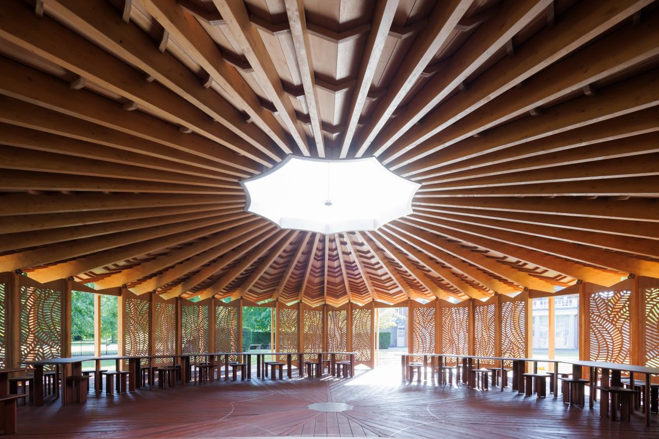 Round wooden pavilion with decorative wooden screens