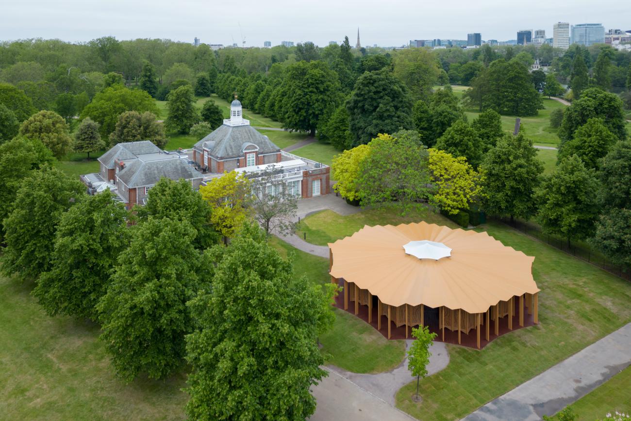 Round wooden pavilion with decorative wooden screens