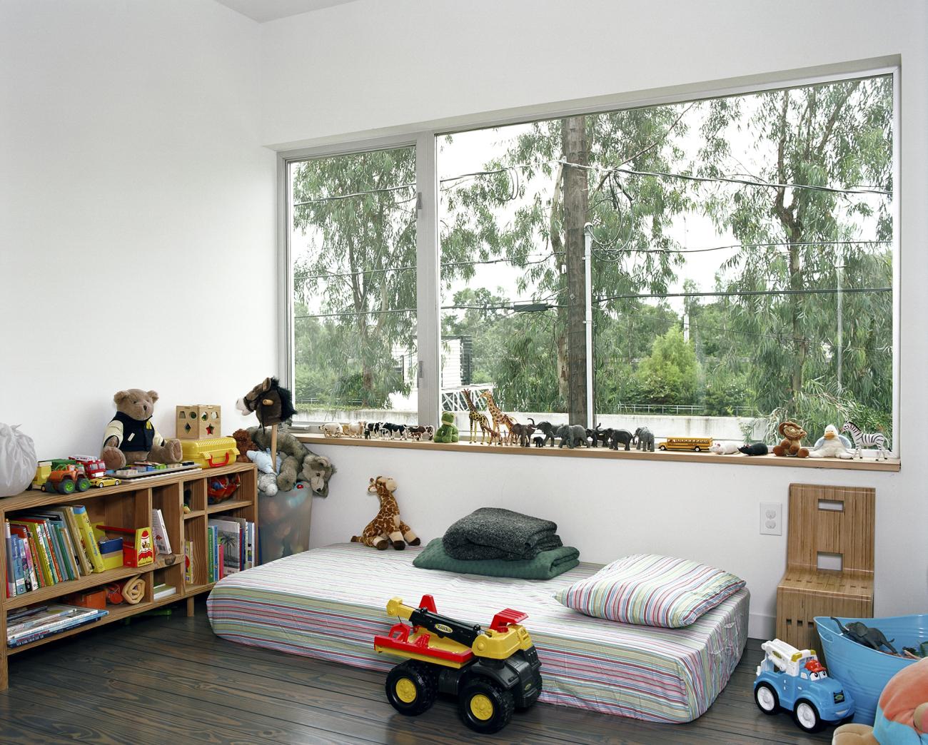 Second level bedroom with view to top of sound wall and TxDOT planting beyond