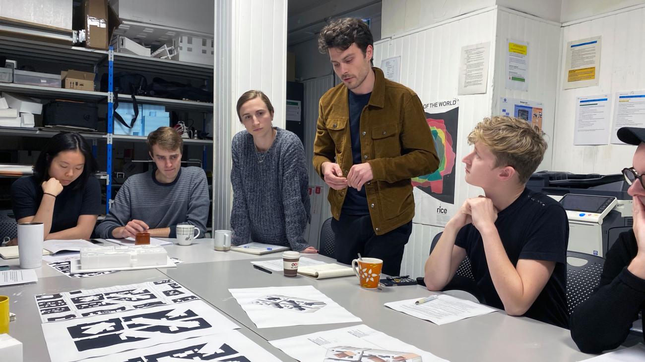 Man interacting with students at a table