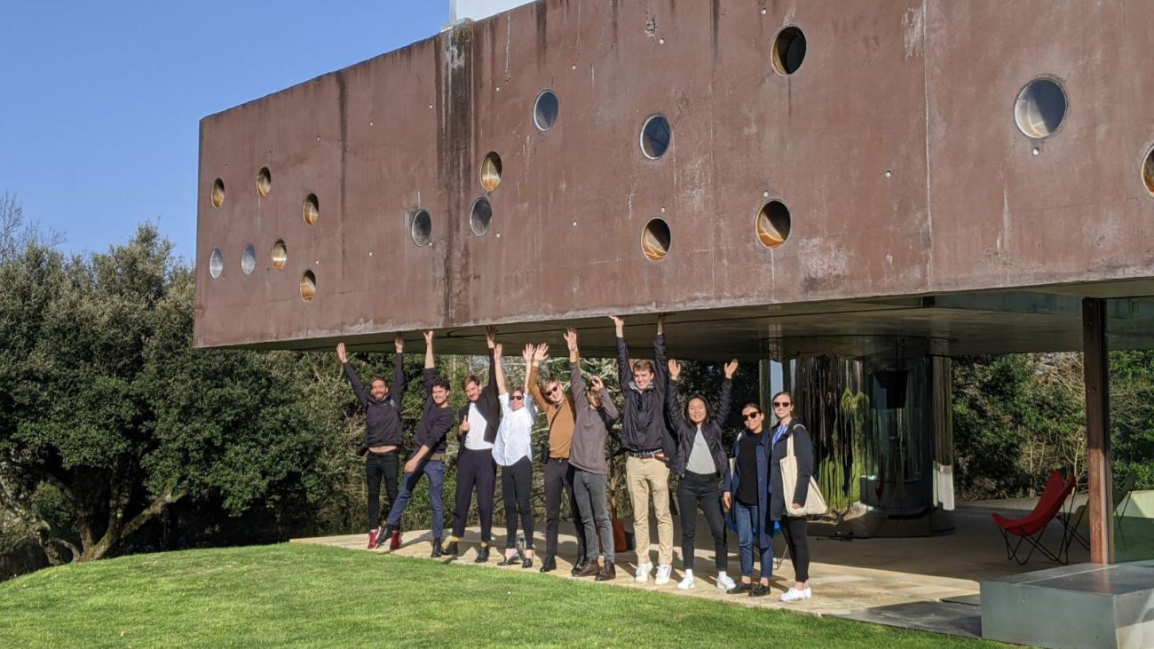 Students posing pretending to hold up an awning