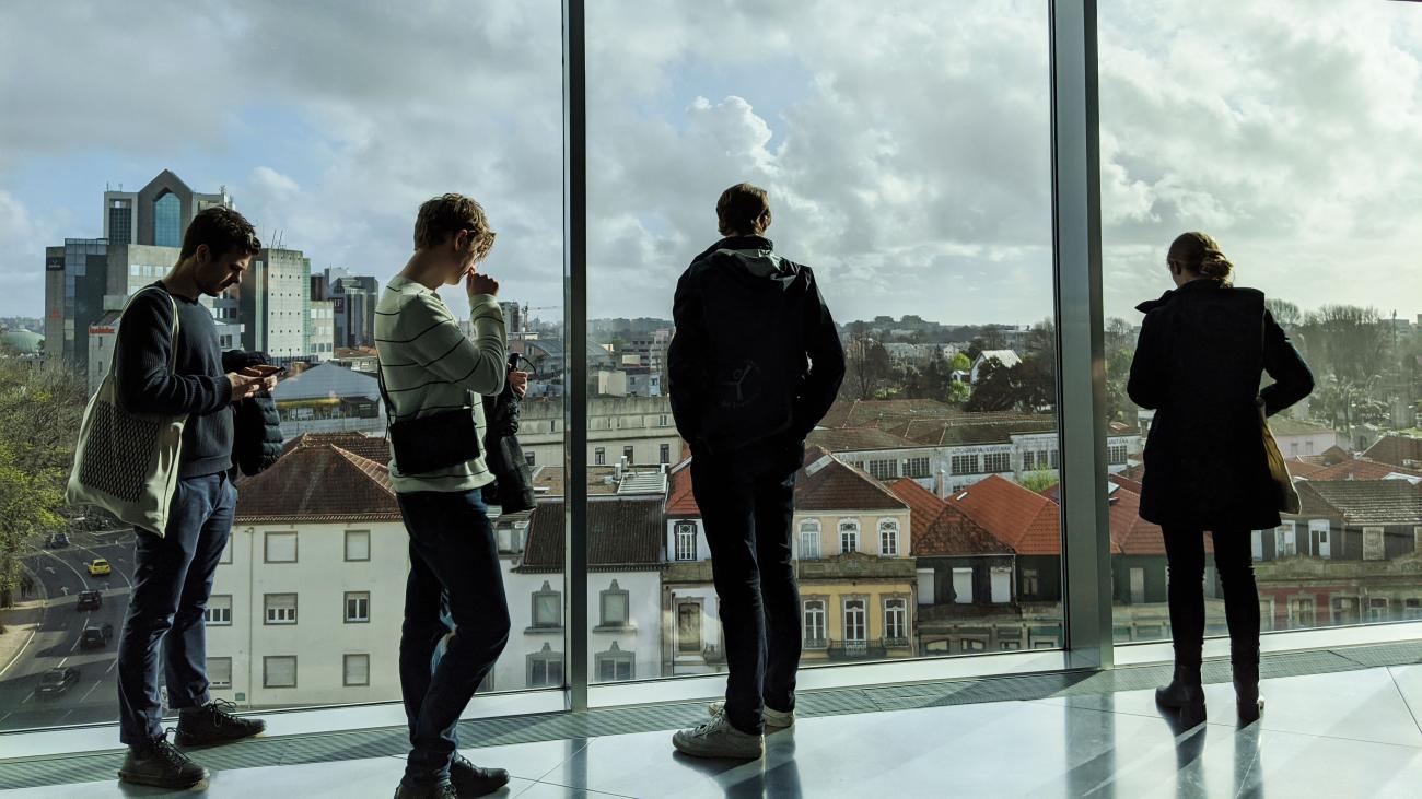 Students looking out of a window into Paris